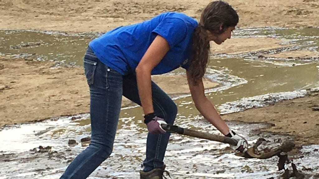 Photo: Service Pump's data scientist, Skye, shoveling mud as part of the cleanup following the 2016 floods in West Virginia. 